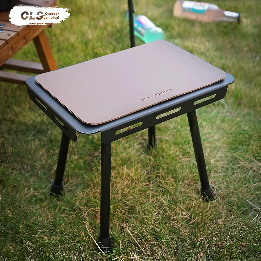 CLS aluminium dual-use camping stool shown in table mode with PU mat cushion, beside its storage bag.
