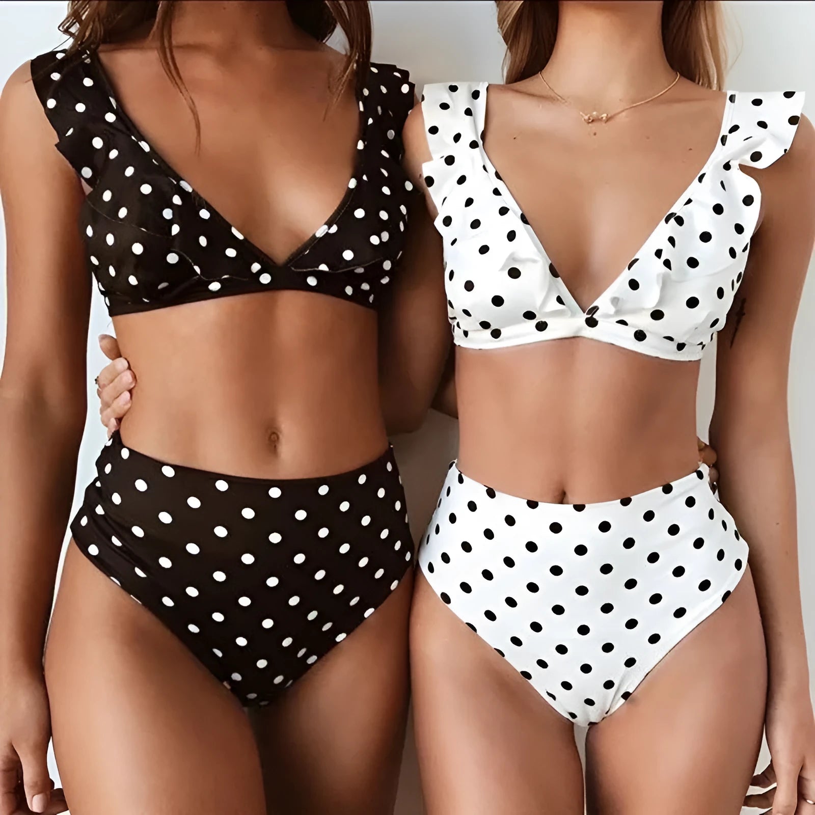 Black and white polka dot print bikini set with deep V-neck ruffled top and matching shorts