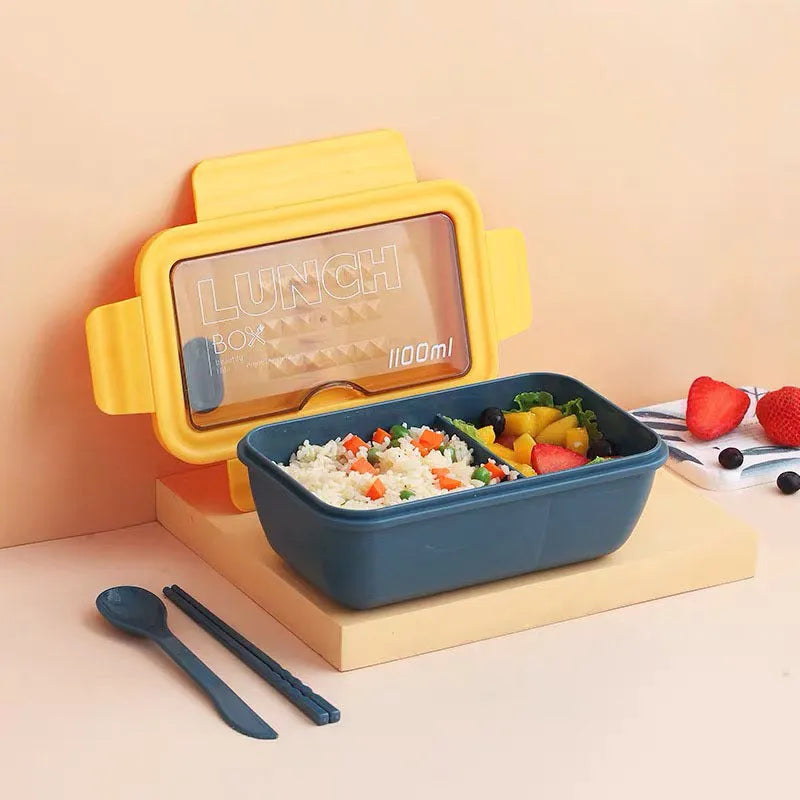 Green Japanese bento box with four separate food compartments and Nordic-style design