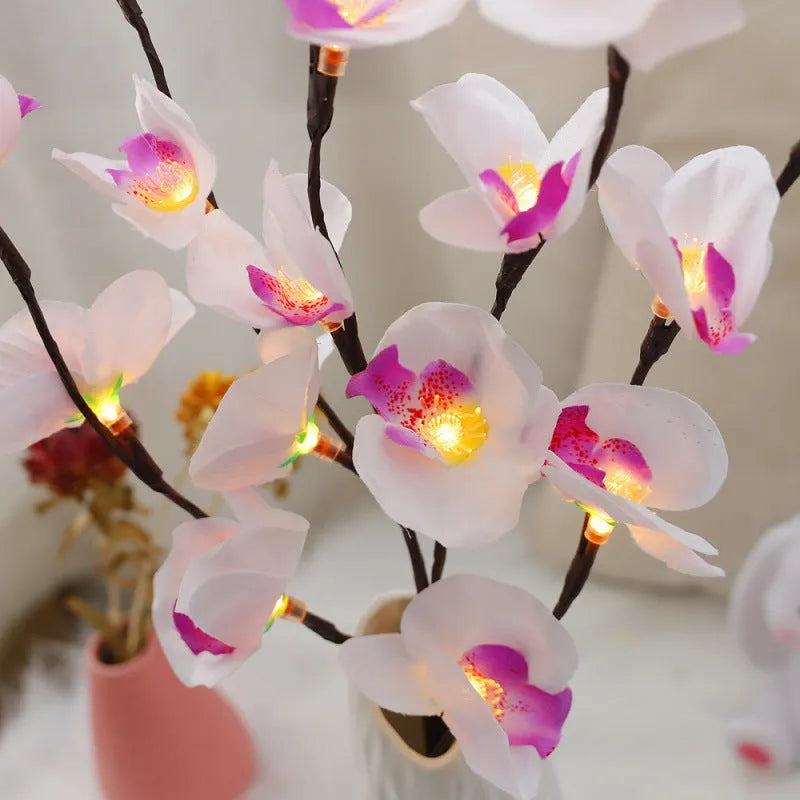 Pink LED phalaenopsis orchid branch decorative light on a table