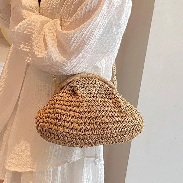 Women's beige shell-shaped paper straw bag with a metal chain strap.