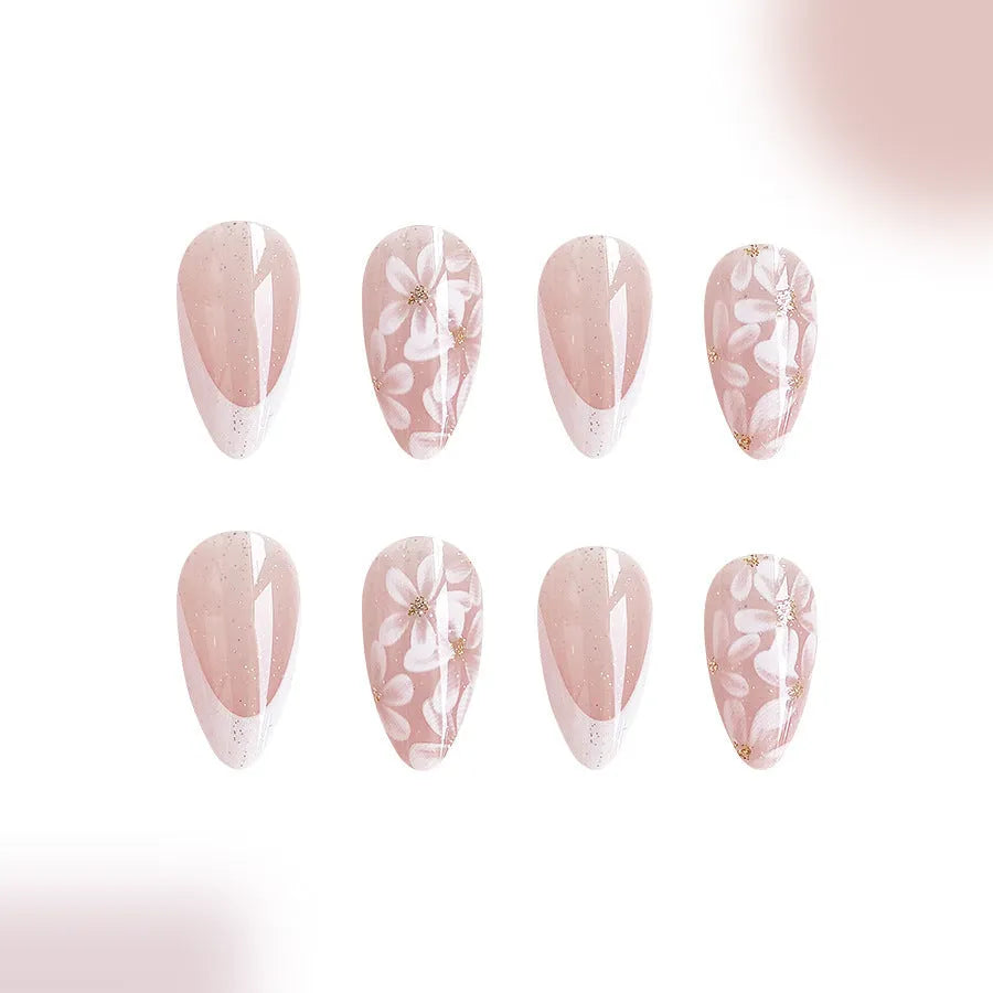 Short glossy almond artificial nails with French tip and glitter flower decorations