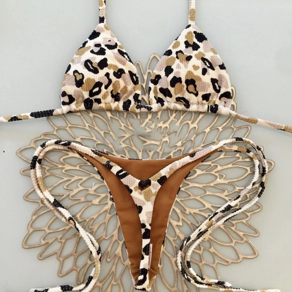 Women's printed bikini swimsuit on a hanger, showing briefs style and cotton lining detail.