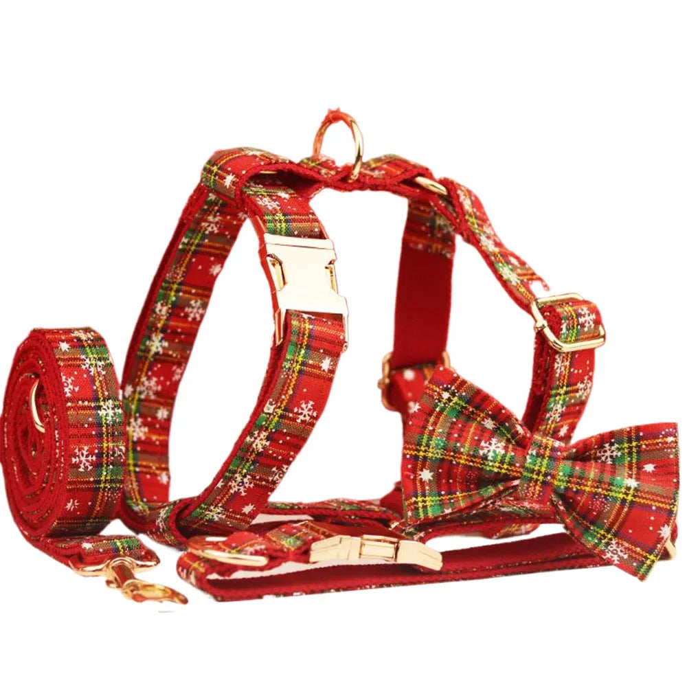 Red snowflake plaid dog collar and leash set with matching vest and decorative bow.