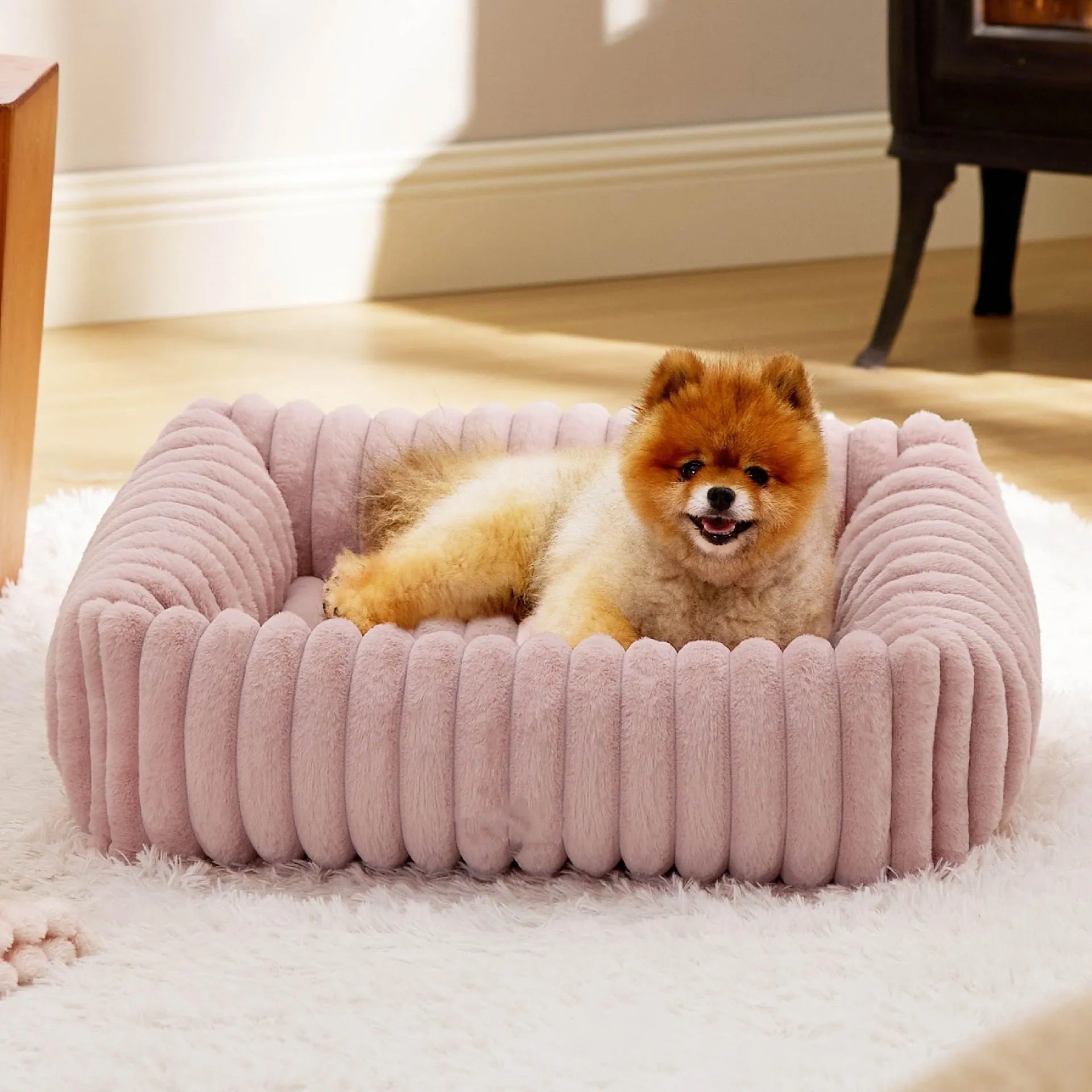 A beige winter-warm cushioned pet bed for cats and dogs on a wooden floor.