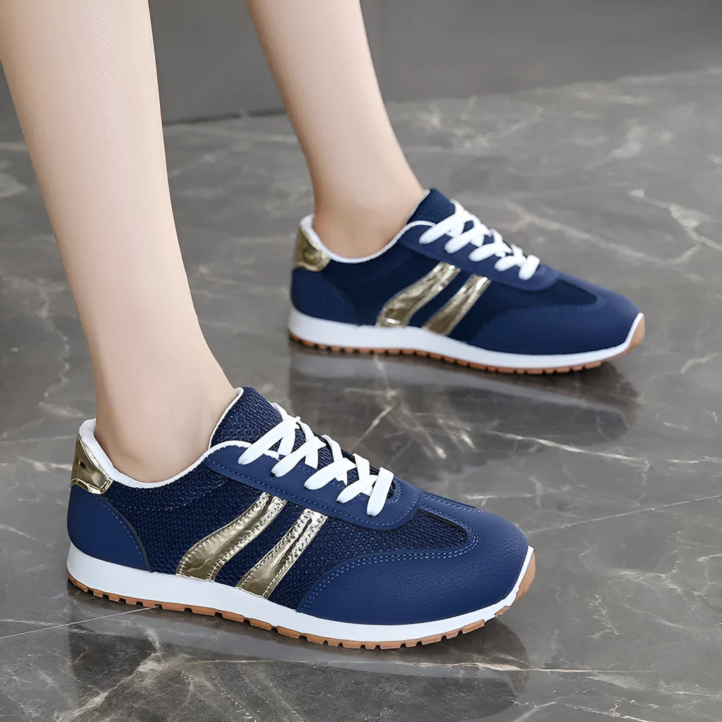 Blue women's casual tennis shoes with cross shoulder straps and a lace-up front on a rubber sole.