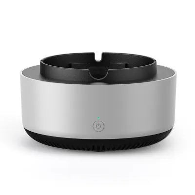 Grey intelligent electronic air purifier ashtray on a table with cigarette