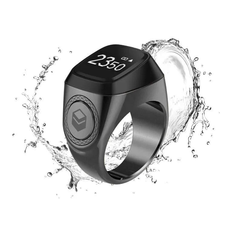 Zikr1 Lite smart ring in silver on a charging case, showing its OLED display and single button.