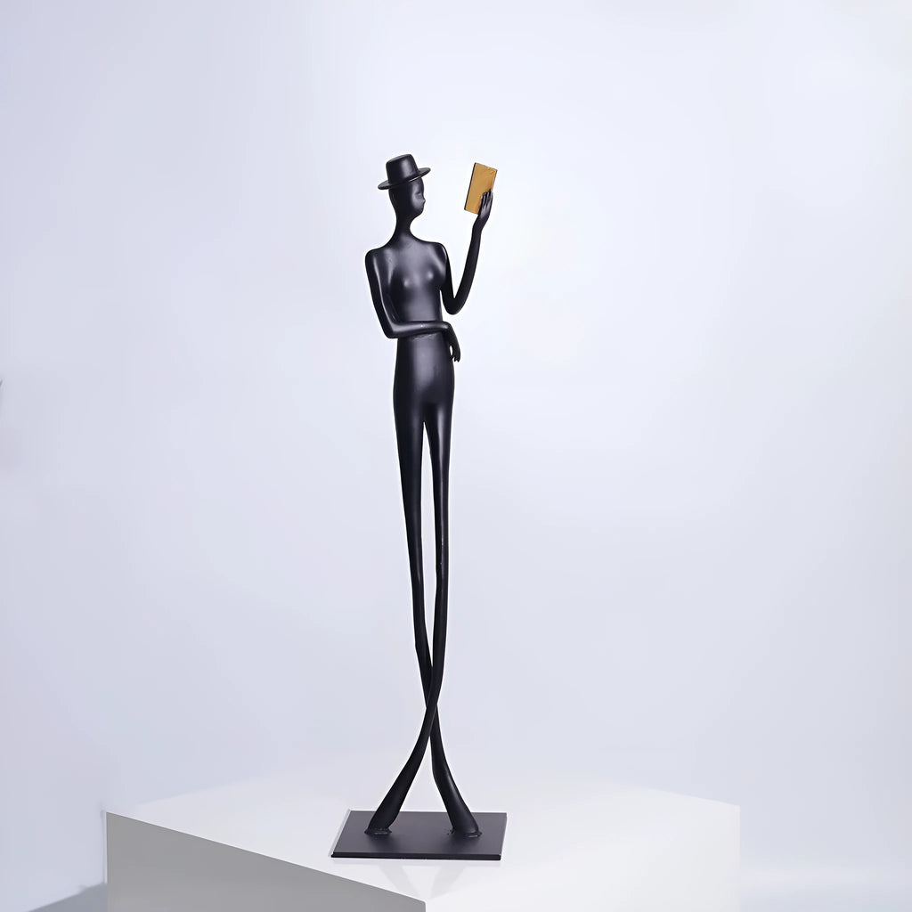 Black cast aluminium desktop sculpture of a reading woman, modern simplicity style