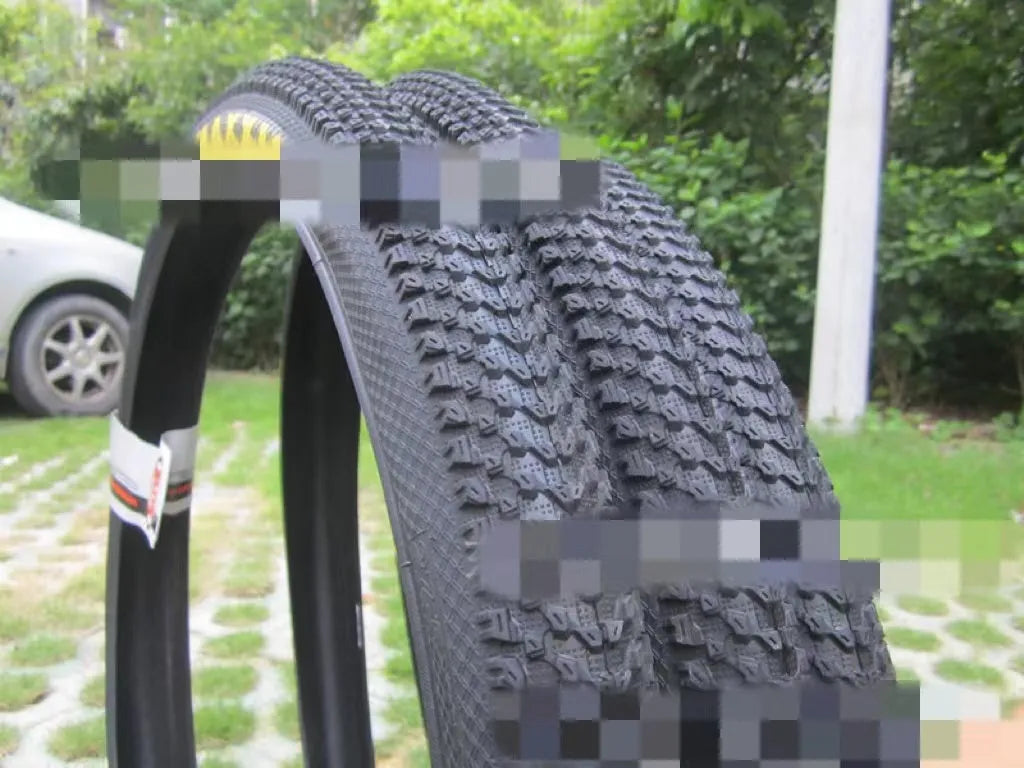 Ultralight puncture-proof mountain bike tyre showing tread and available size options: 26, 27.5, 29 inch.