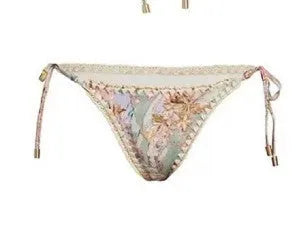 Women's creamy-white floral bikini set with separate skirt on beach
