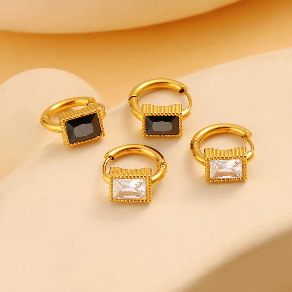 A pair of square geometric zircon stainless steel earrings on a white background.