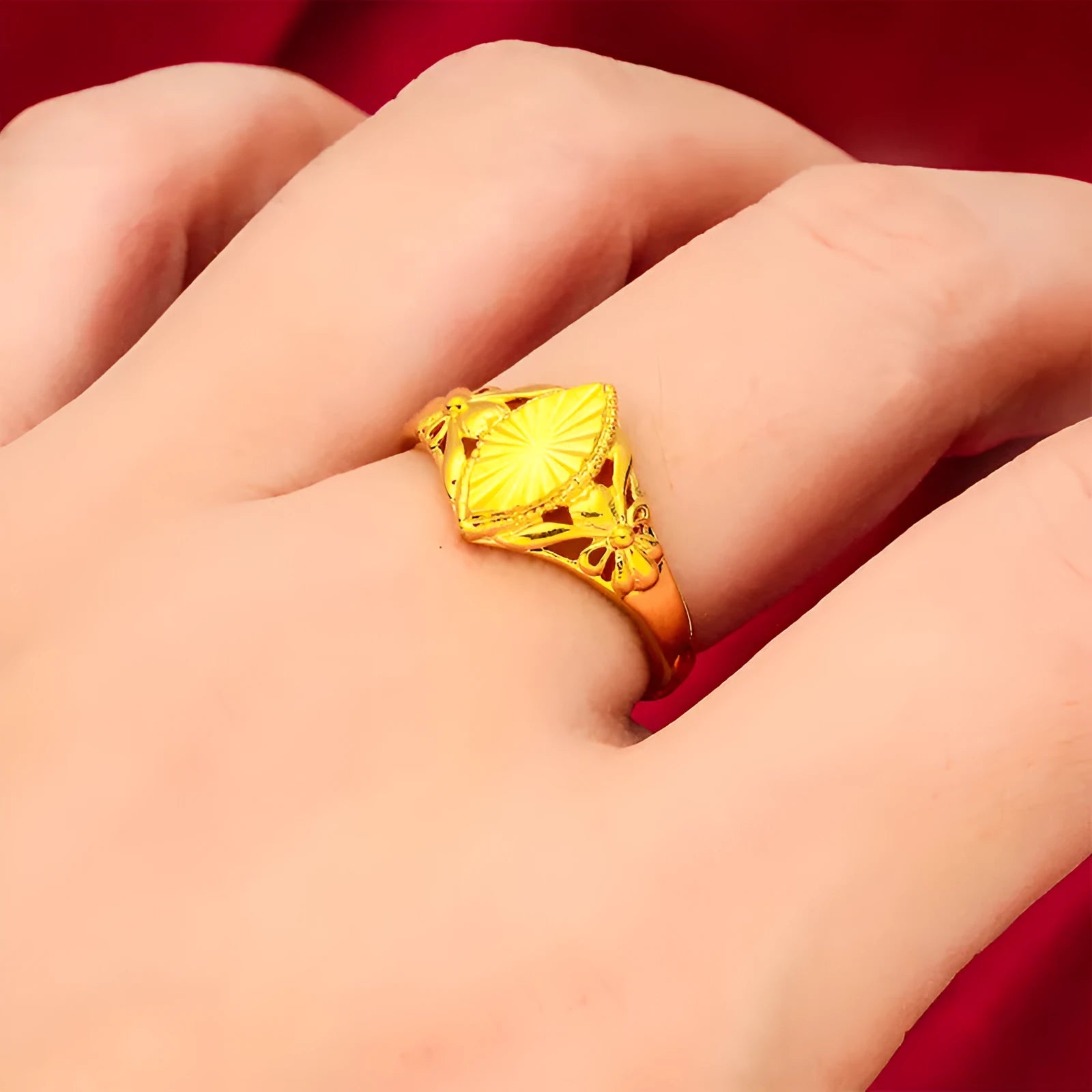 Gold-coloured geometric flower ring with textured surface and open design on brass