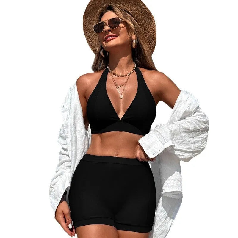 Women's black split bikini swimsuit with sleeveless design on a mannequin.