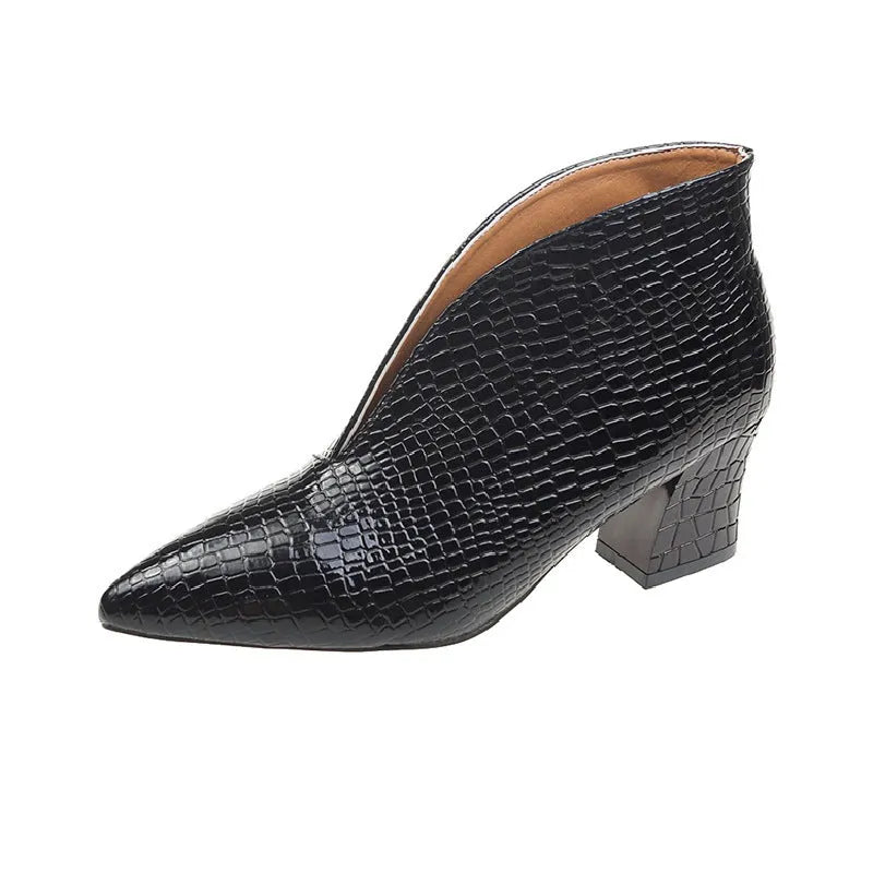 Women's black V-cut pointed toe Martin boots with a chunky heel on a rubber sole