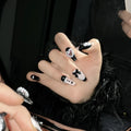 Handmade black peach heart nail art with detachable bow patterns on plastic armour suit