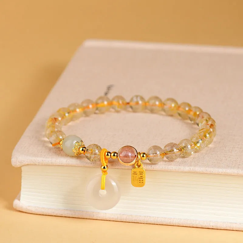 Gold rutilated quartz crystal bracelet with safety buckle and geometric pendant