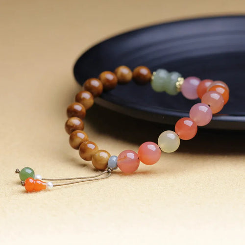 8mm diamond-shaped agate bracelet with natural persimmon colouration on woman's wrist