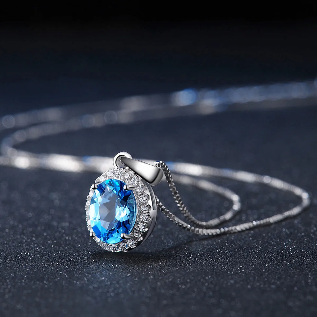925 sterling silver jewellery set with blue topaz gemstones including earrings, ring, pendant and necklace