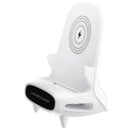 White mini chair shaped wireless charging stand holding a mobile phone at an angle