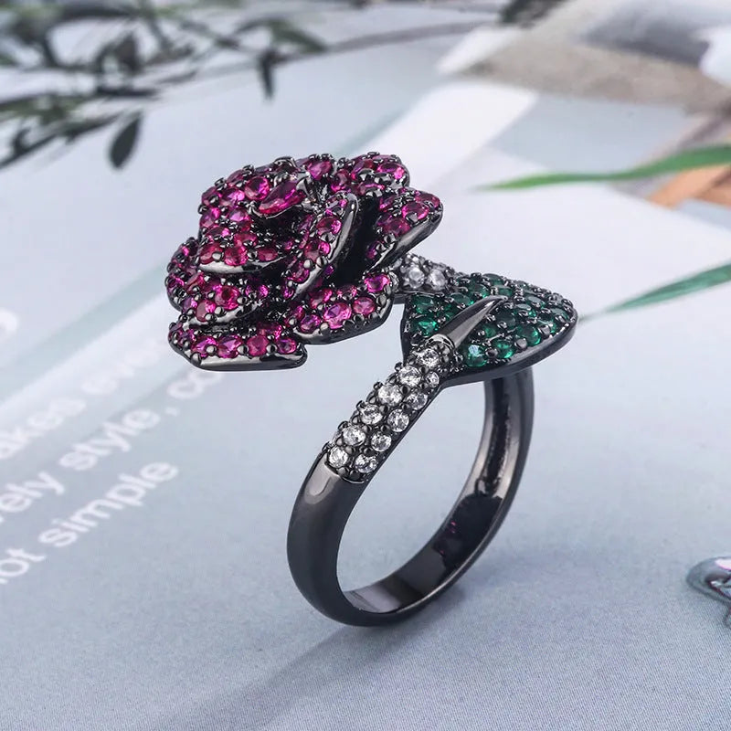 Geometric black gold flower ring with simulated red corundum centre stone
