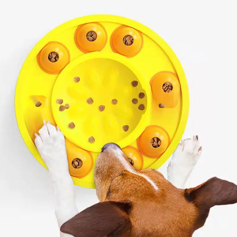 Round blue interactive dog slow feeder puzzle toy with central column and food turntable on a table