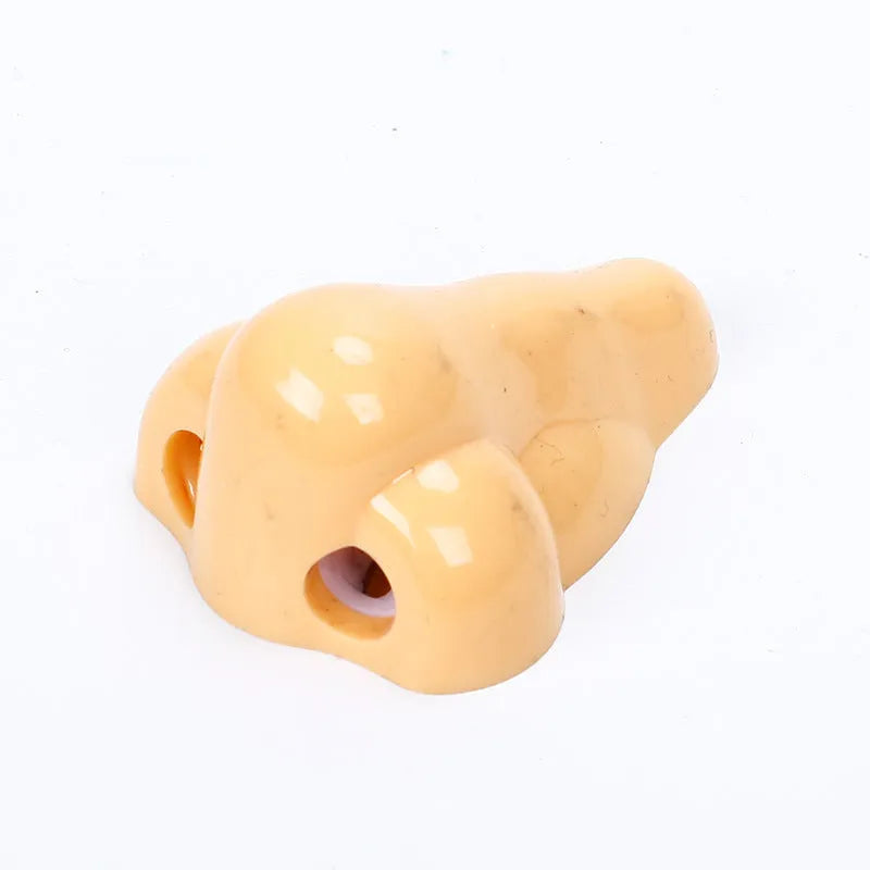 Flesh-coloured geometric pencil sharpener with a big hole for large pencils on a white background.