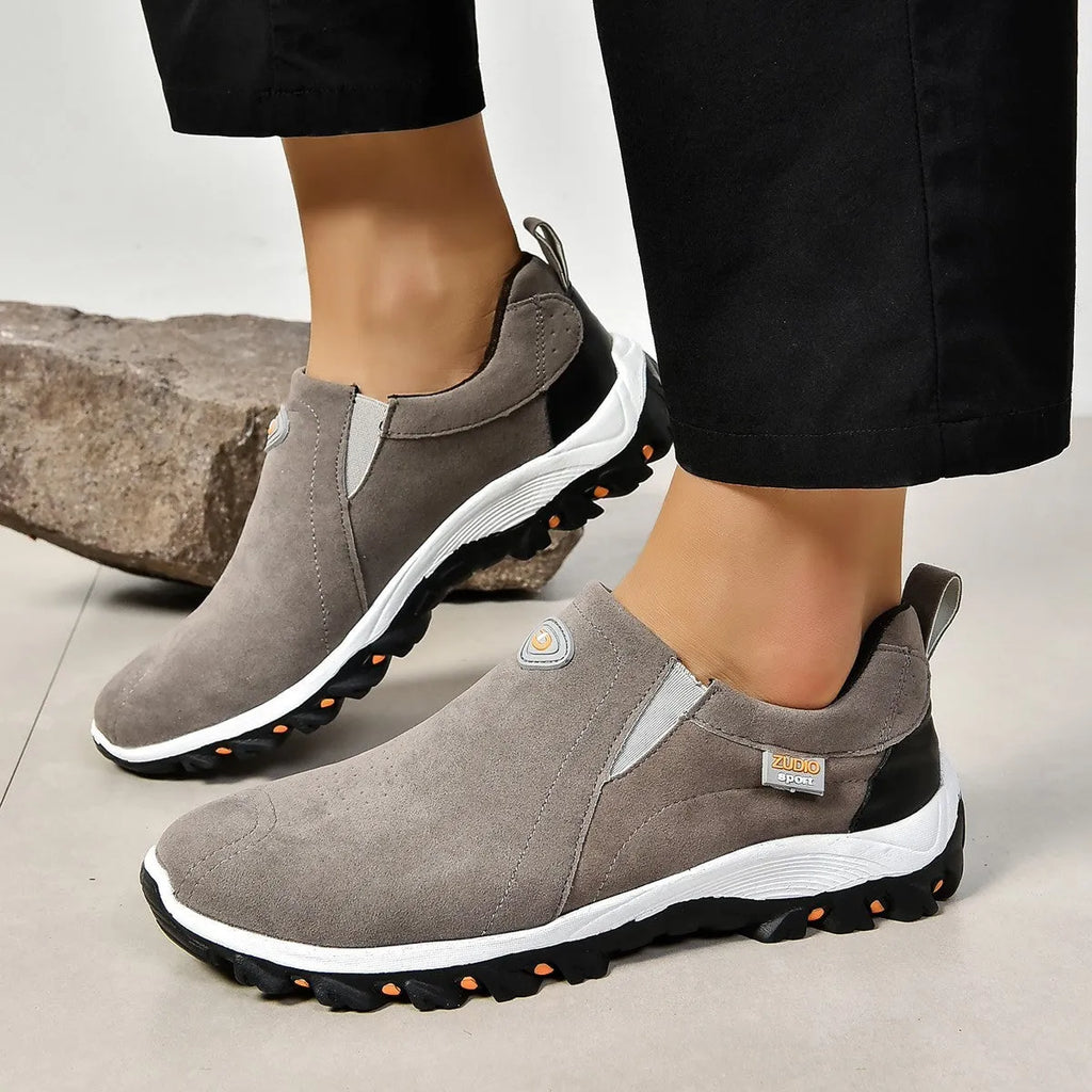 Men's thin oversleeve shoe cover in light brown with a round toe, shallow mouth, and rubber sole.