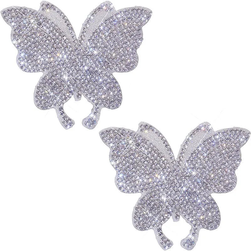 White diamond-encrusted car sticker patch showing butterfly and bear claw designs on a 7x6 cm glass base.
