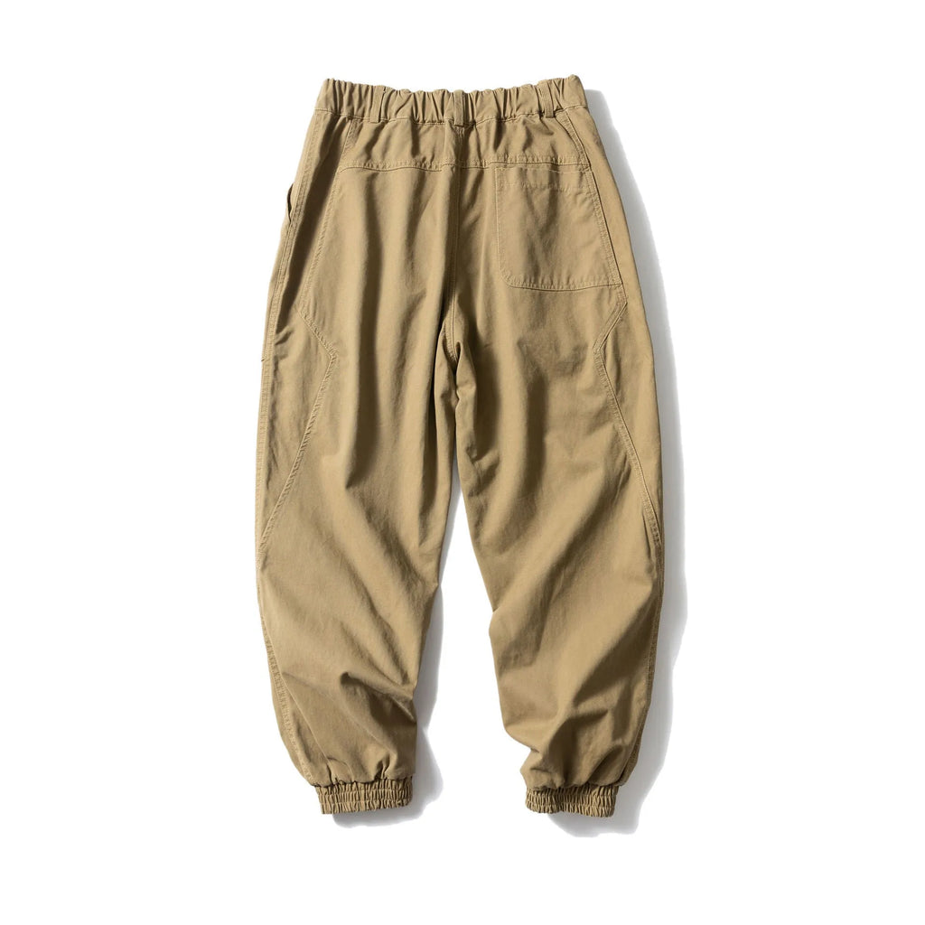 Black cotton tapered casual pants with ankle tie and large pocket.