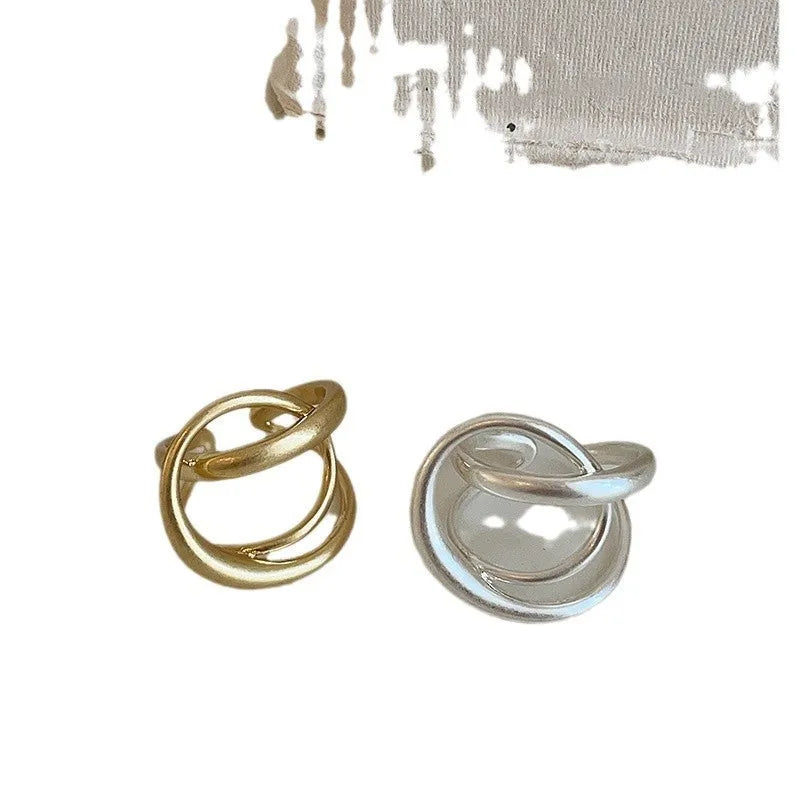 Women's geometric open ring with three-dimensional interlaced matte metal design in gold or silver with real gold electroplating