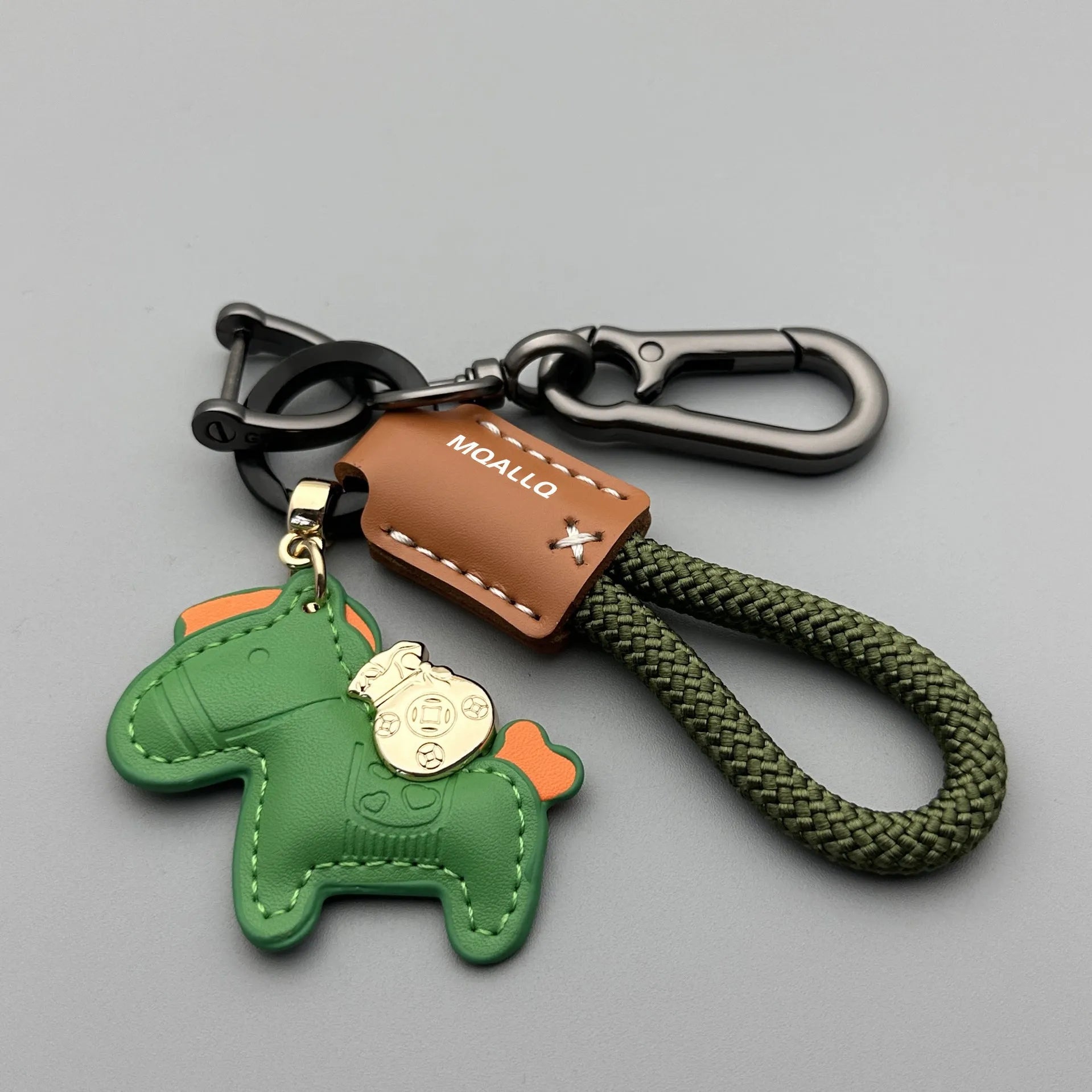 Handmade cowhide car key ring pendant with zinc alloy pony belt buckle charm and flanelle rope in various colours.