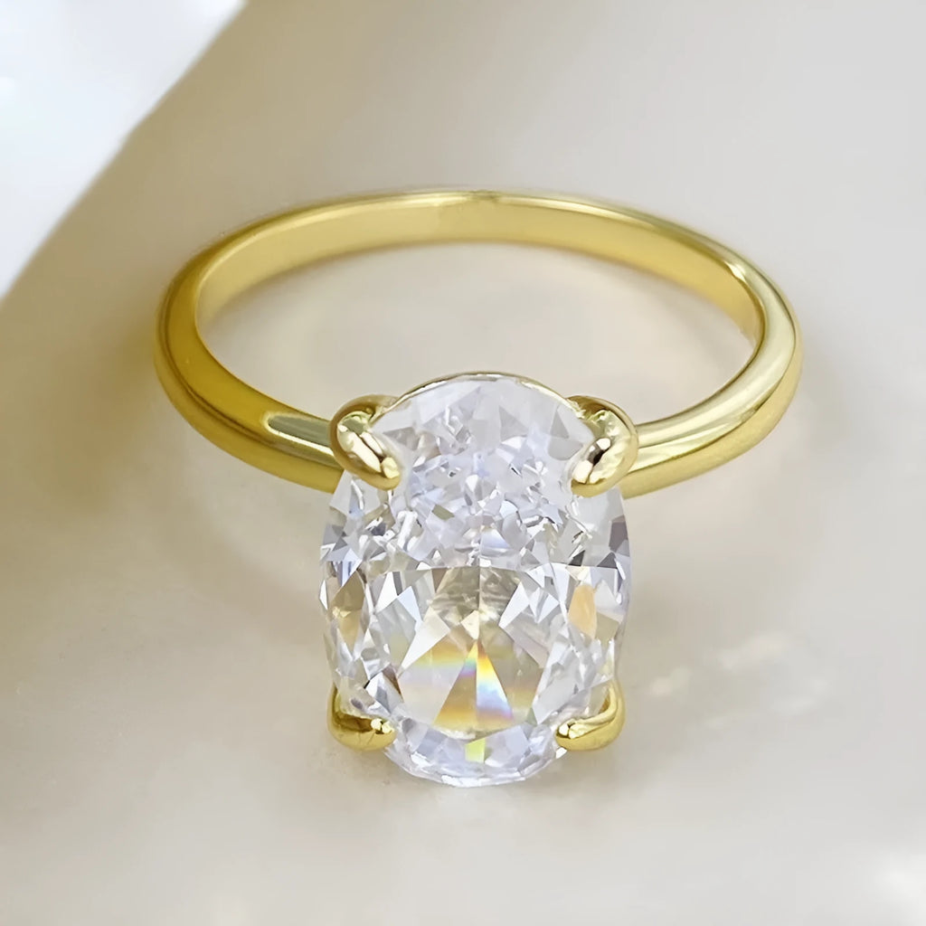Oval gemstone ring in a four-claw setting on a silver band.