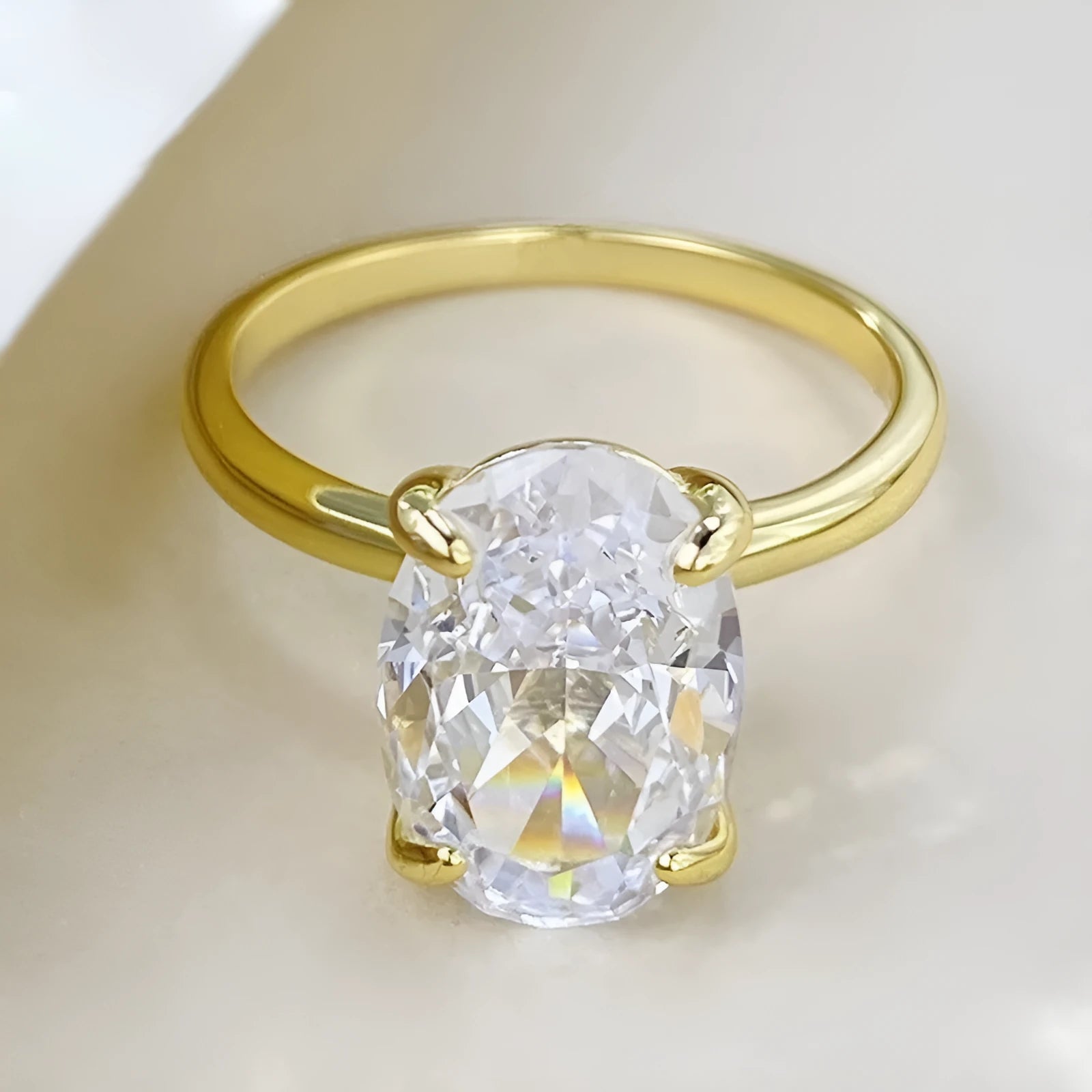 Oval gemstone ring in a four-claw setting on a silver band.