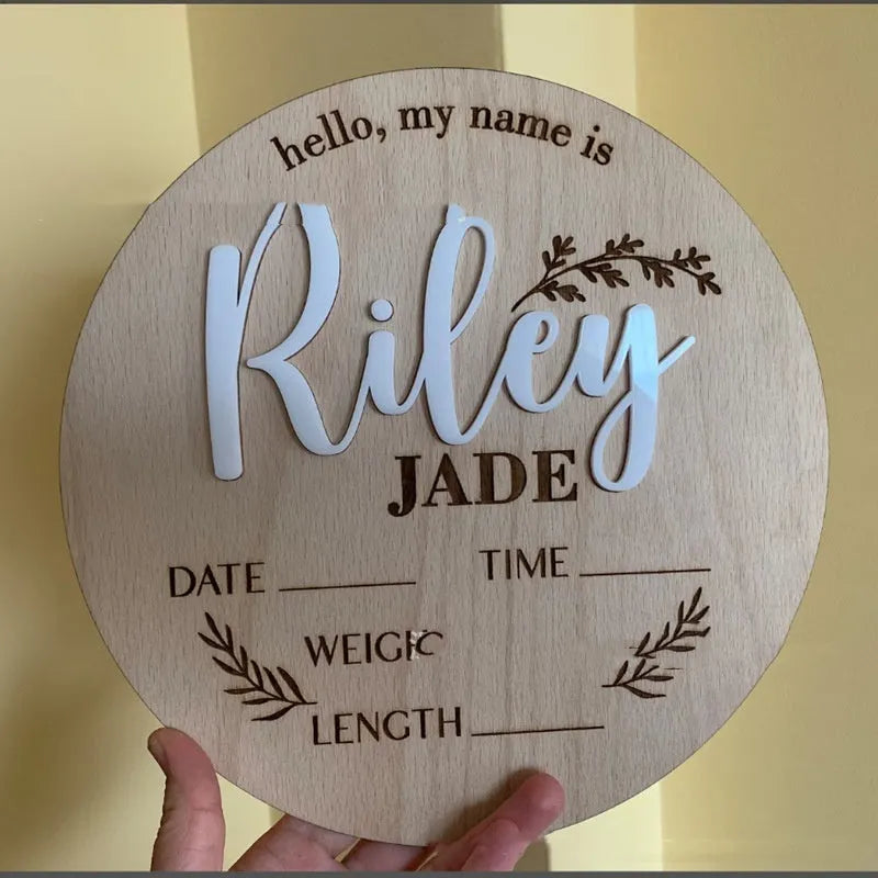 Square wooden name plaque engraved with newborn birth details for nursery wall display