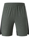 Men's forest green five-point stretch shorts laid flat.