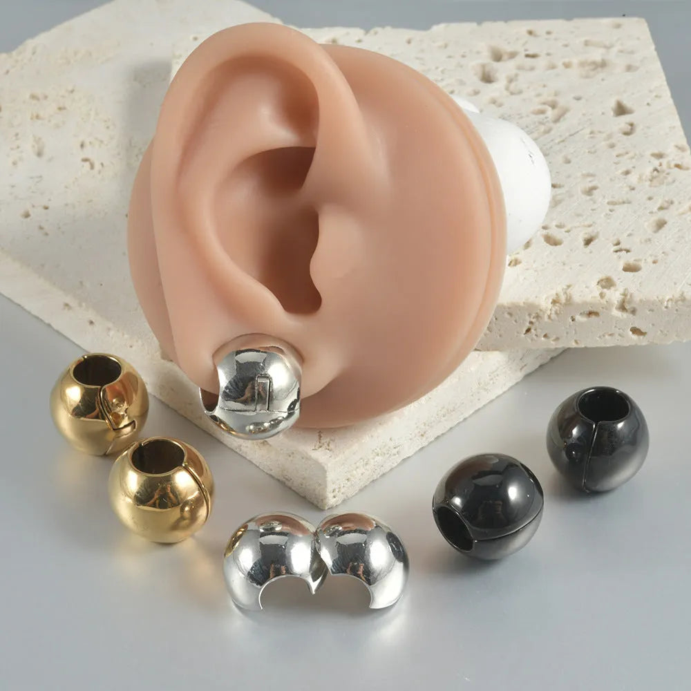 Stainless steel hollow skull Buddha earrings in hip hop style with geometric shape.