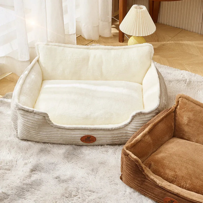 Coffee and white coloured removable washable dog kennel bed shown in small and medium sizes on a sofa and floor.