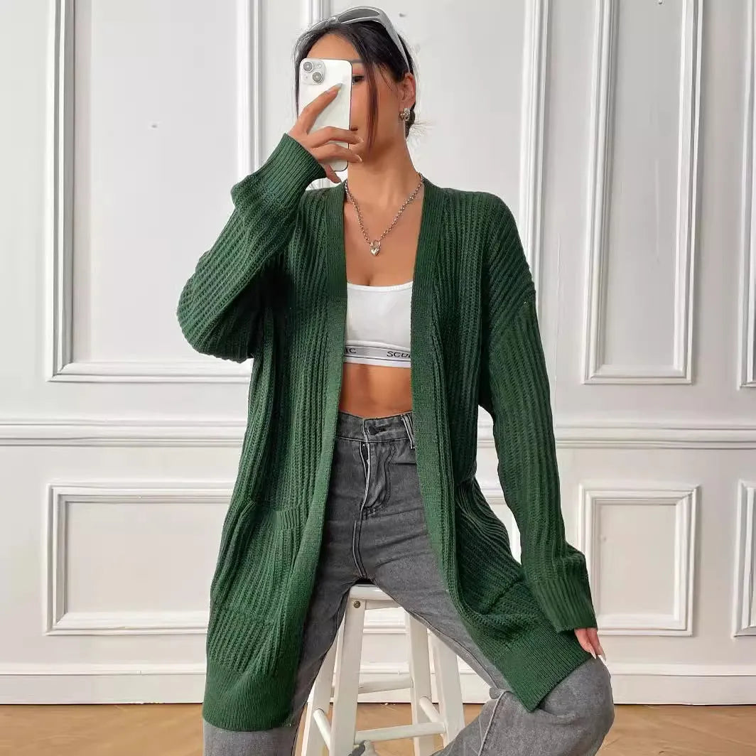 Women's dark green double pocket cardigan sweater with a V-neck and long sleeves laid flat.