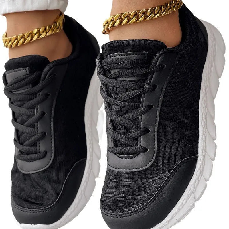 Women's white canvas casual sports running shoes with a flat heel and round toe on a plain background.