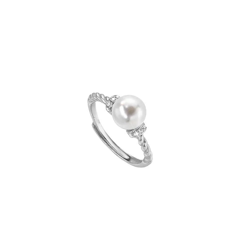 Adjustable antique twist copper ring with an inlaid pearl in gold colour.