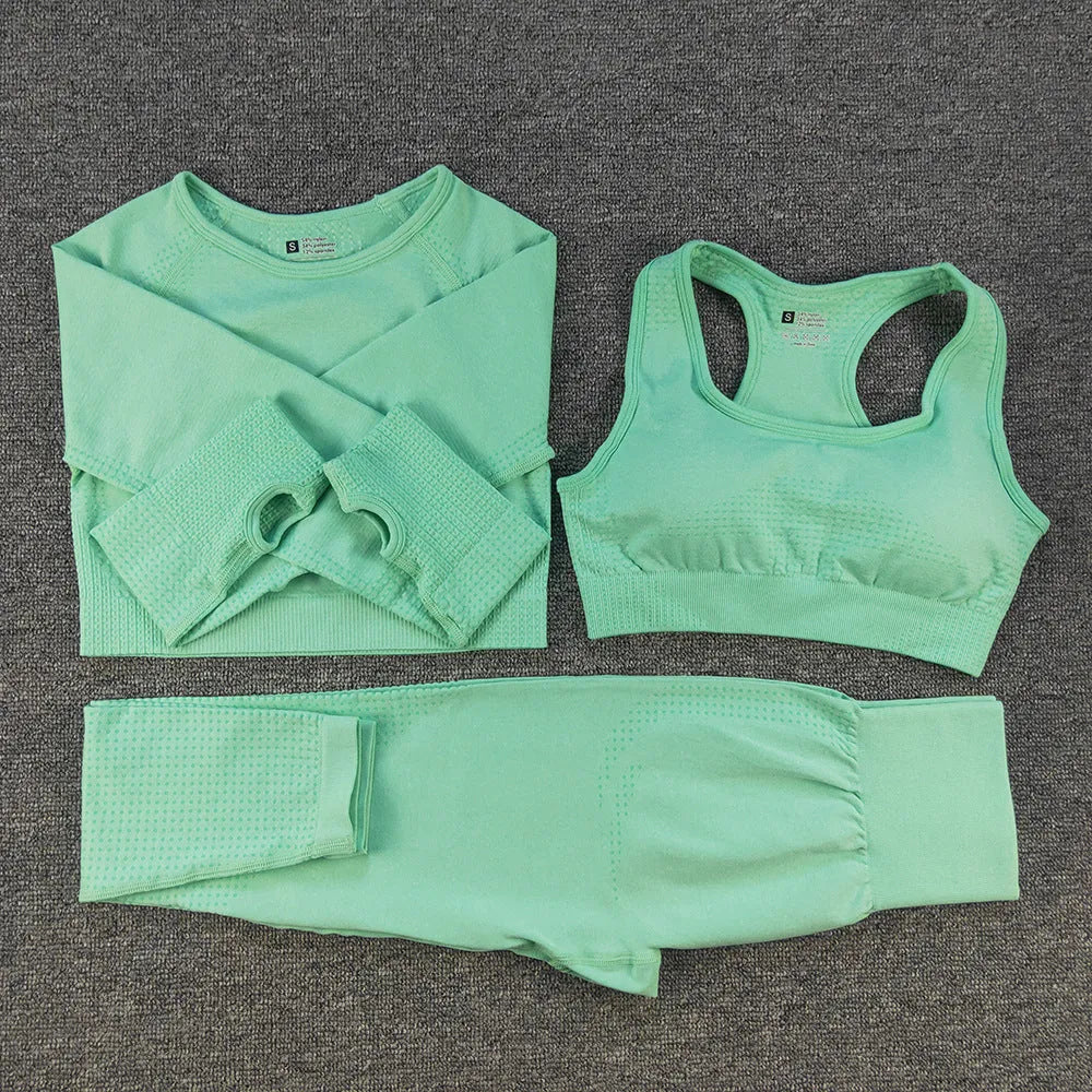 Three-piece yoga clothes set with bra, long sleeve top, and trousers in tight fit nylon blend fabric
