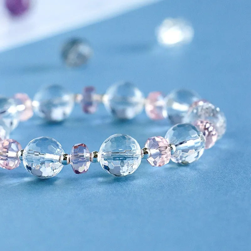 Women's white crystal bracelet with diamond-shaped beads and lucky cat charm