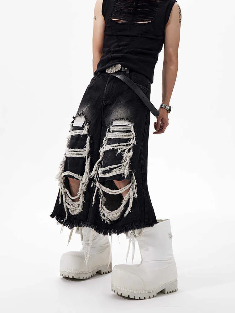 Black cropped wide-leg jeans with mid-high waist and distressed patch detail on micro-elastic denim
