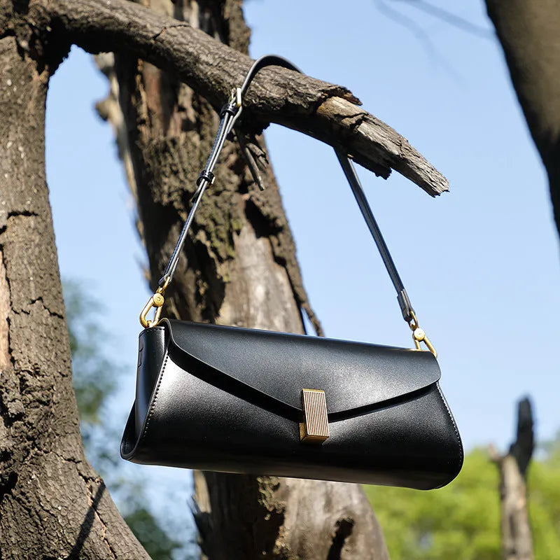 Women's cowhide leather cross-body bag in pillow shape with clamshell opening