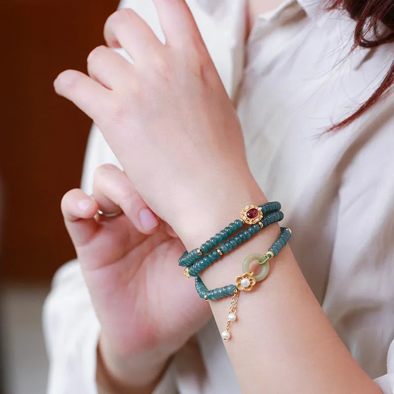 Blue water jade abacus bead bracelet with three silver rings and tourmaline pearls