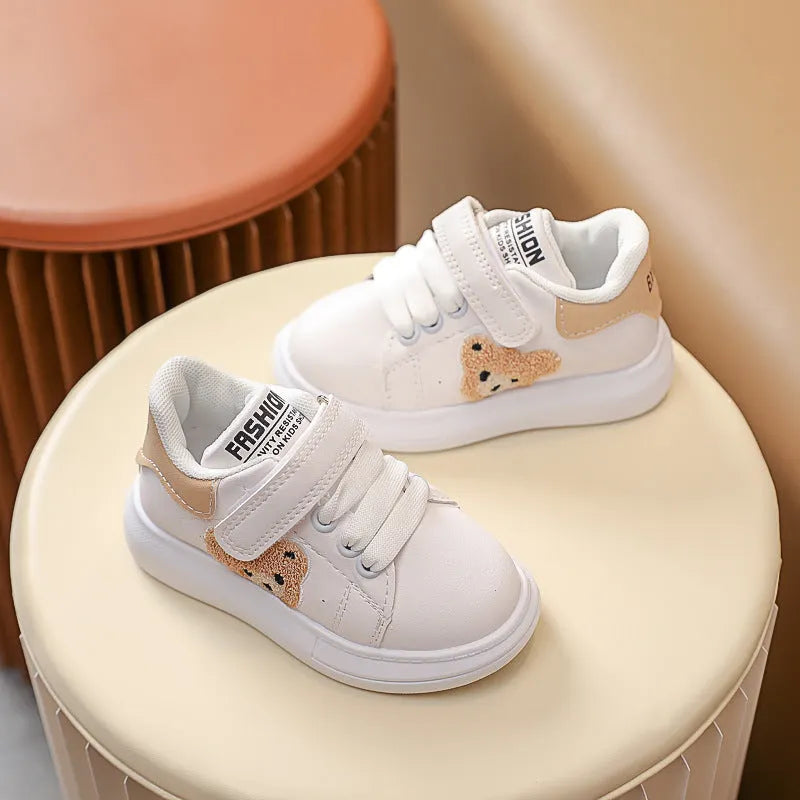 Children's black casual sports shoes with a cartoon bear design on the side, featuring an artificial leather upper and rubber sole.