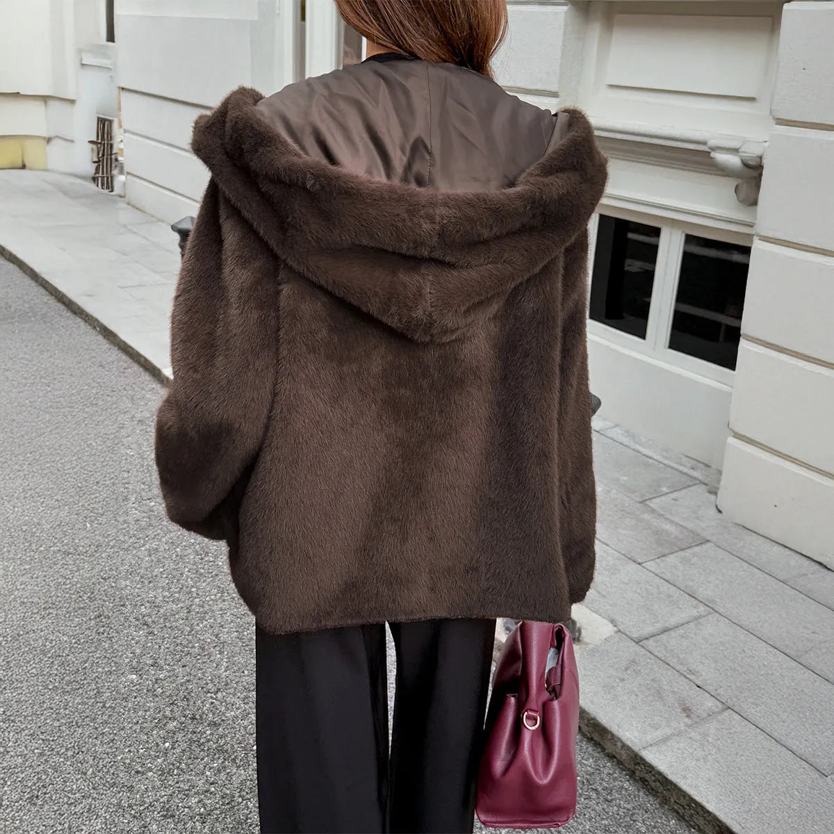 Women's brown polyester coat with fur collar, long sleeves, and regular fit on display