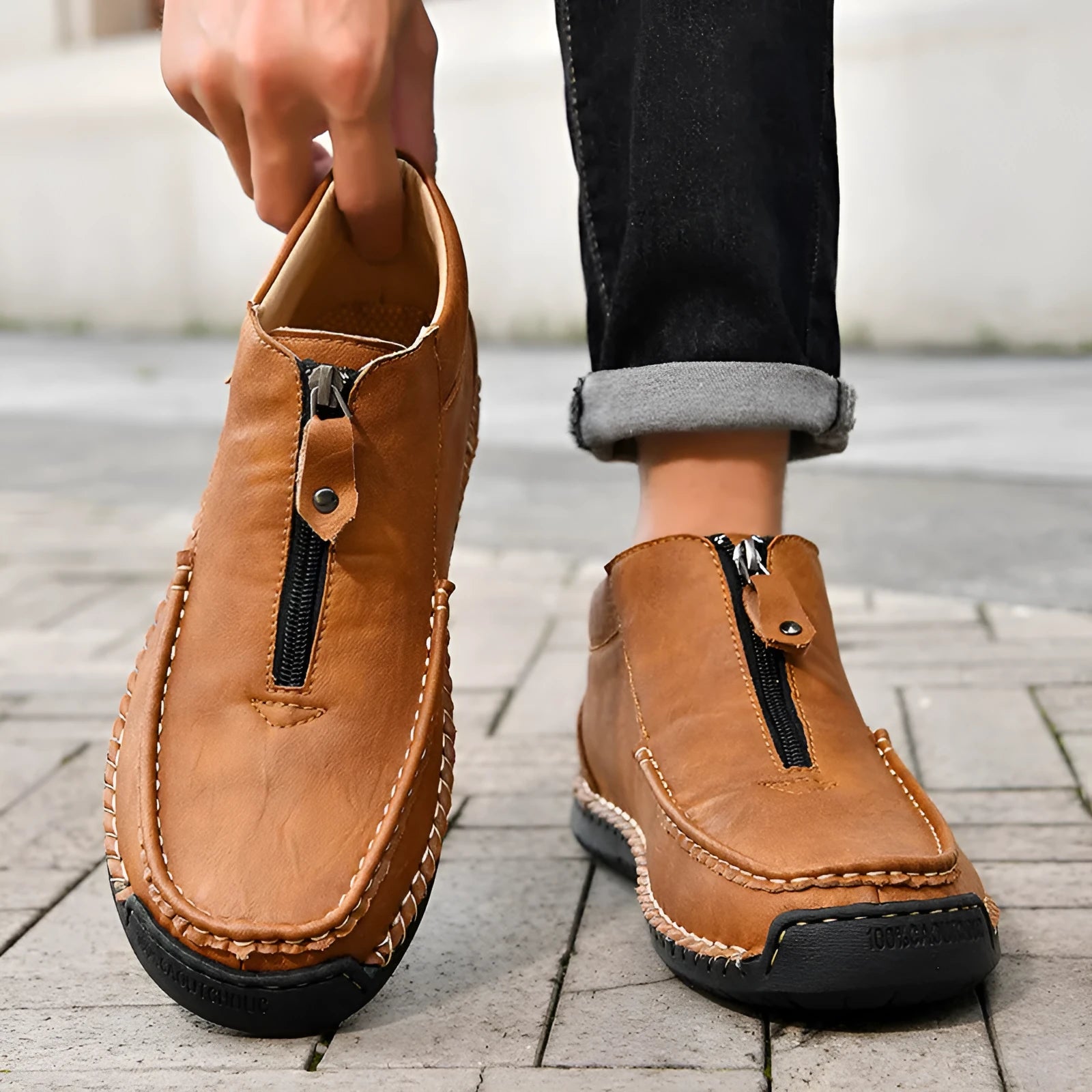 Men's black slip-on leather loafers with round toe and rubber sole on a white background