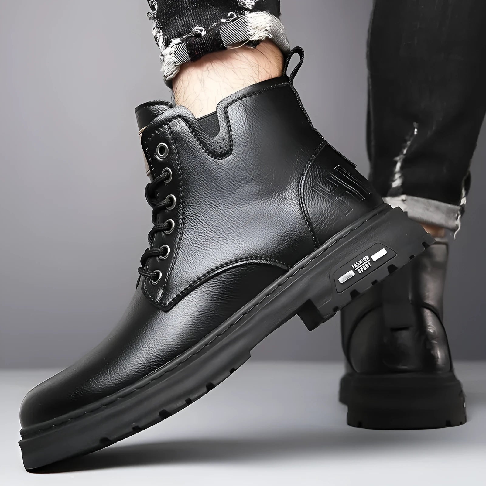 Men's black Martin lace-up boots with thick rubber sole and round toe on a neutral background.